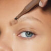 Provoc fork-tip eyebrow pencil on woman's face