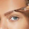 Provoc fork-tip eyebrow pencil on woman's face